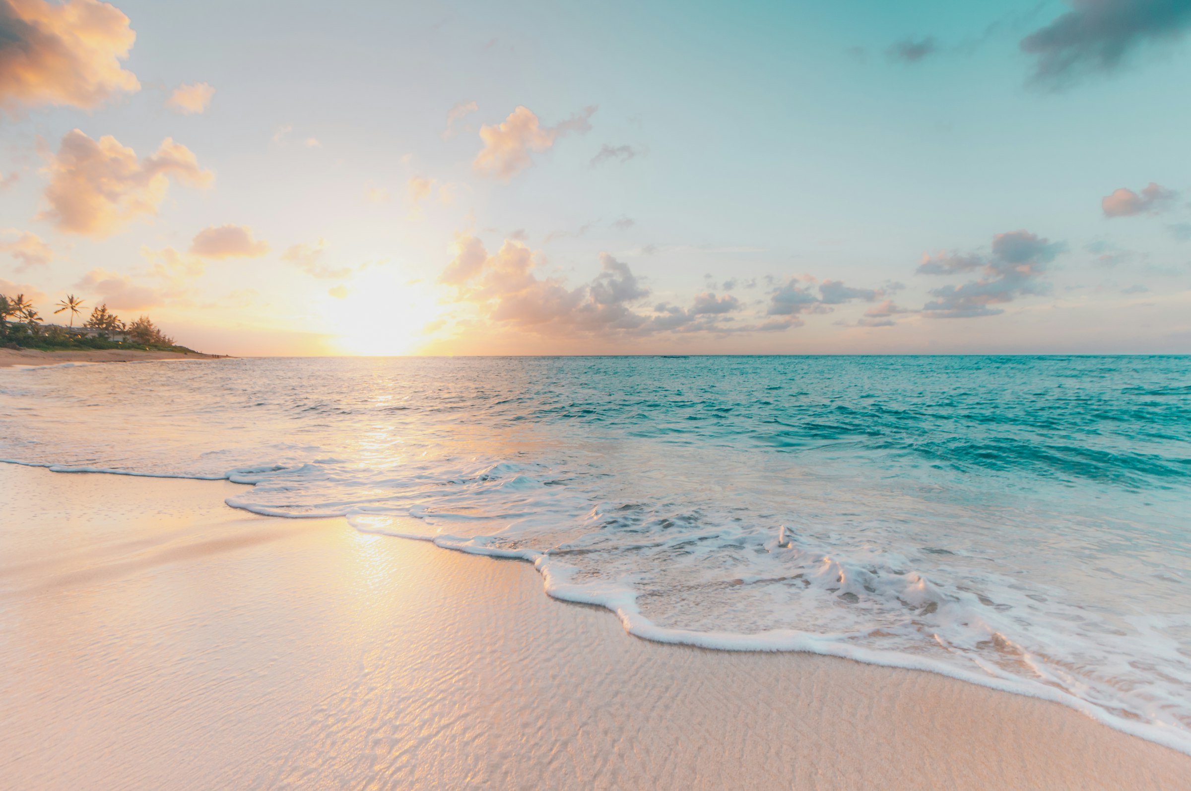 Golden sunrise over a tropical ocean horizon